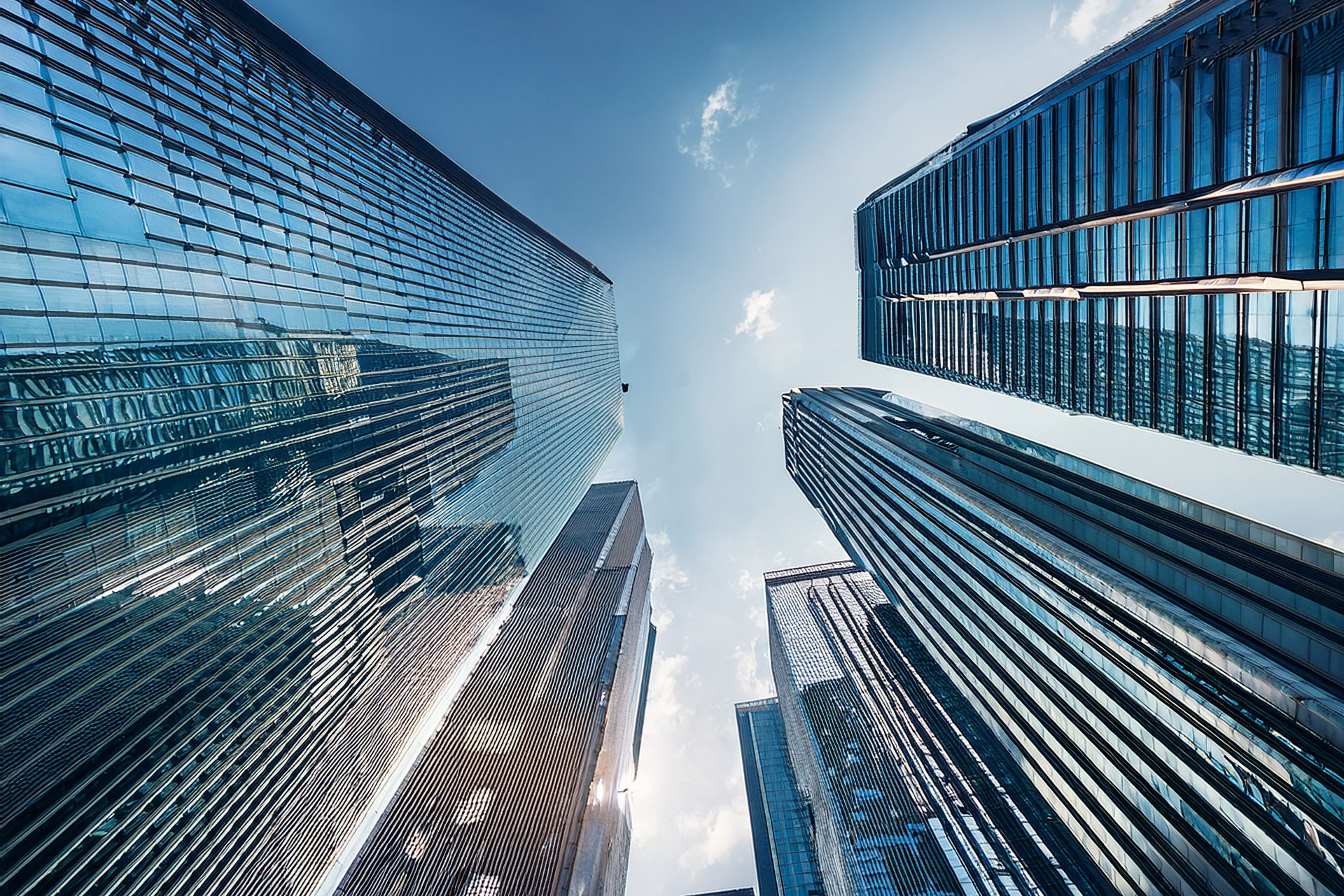 Meet the Founders of Equity Shares: Built by Former Bank Traders. Picture of tall glass sky scrapers
