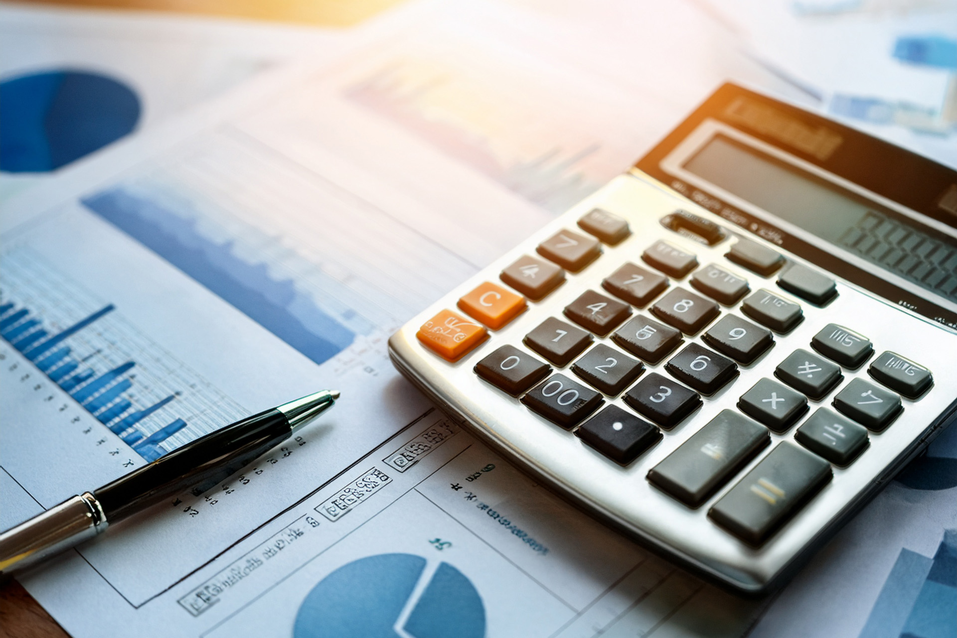 Picture of a calculator, pen and financial documents